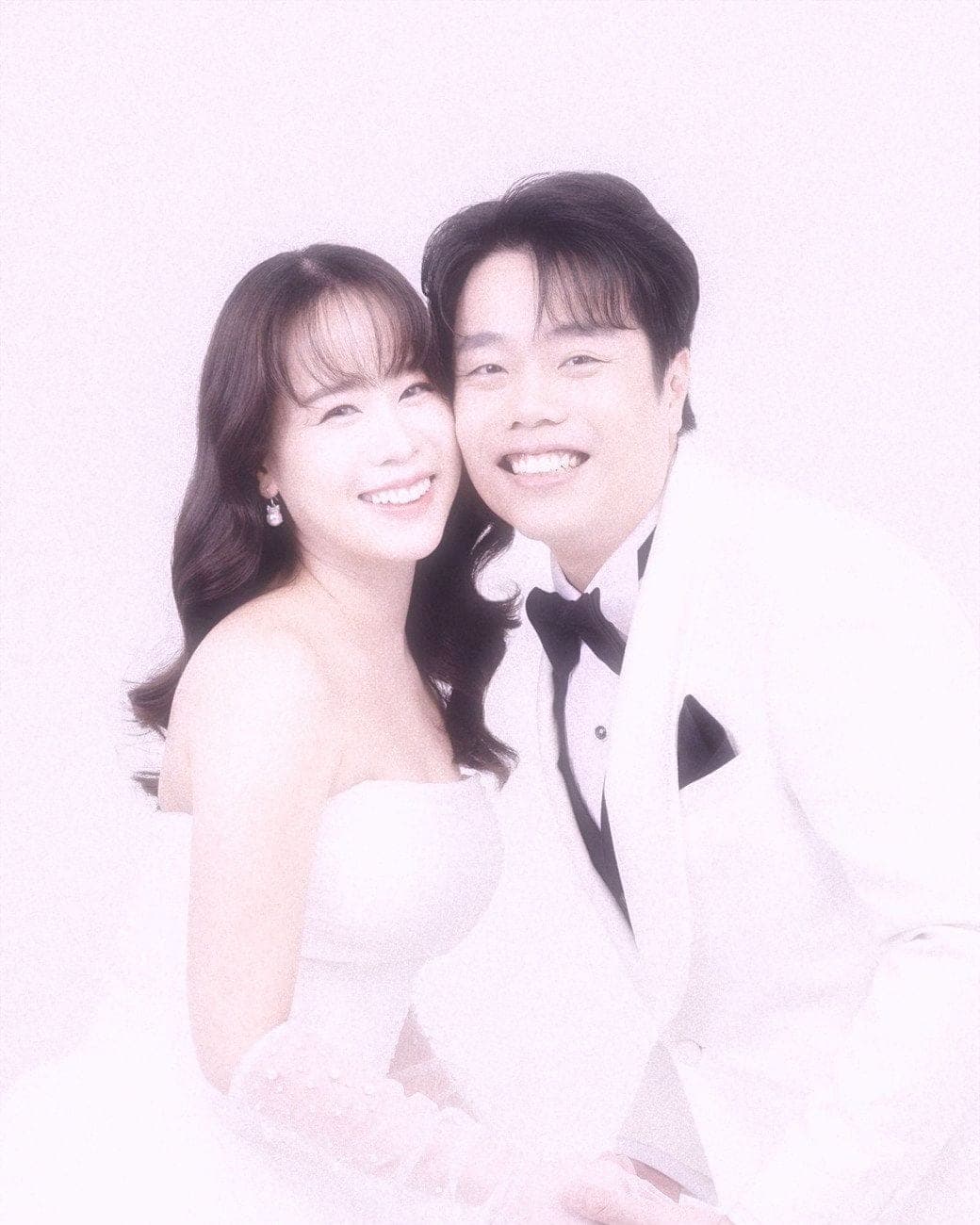 Witita and Sorratat cheek to cheek in white tuxedo and gown